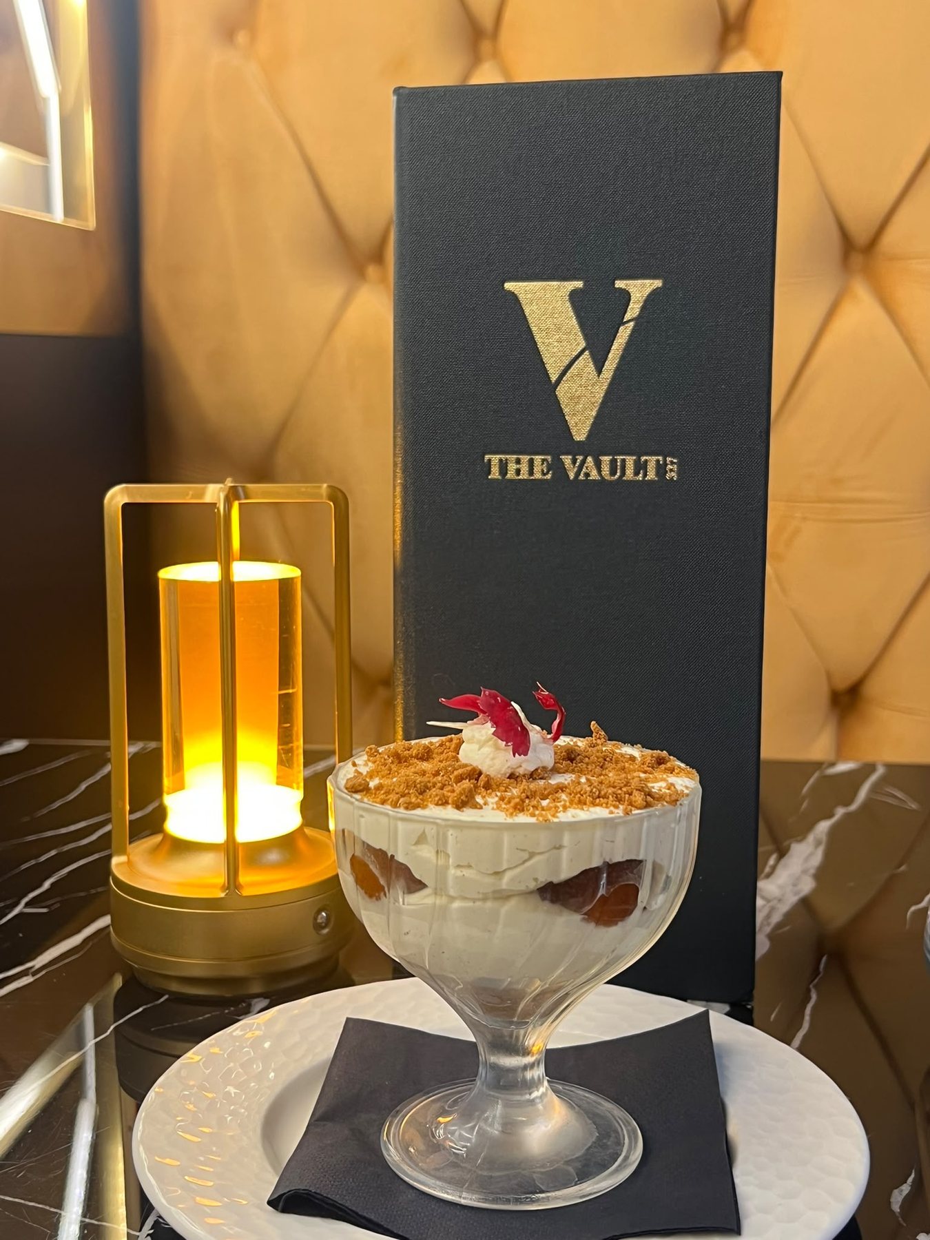 The Vault 327 branded menu by candlelight